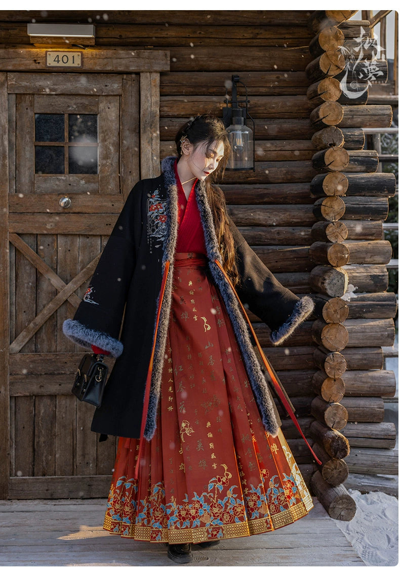 Detailed view of black woolen Hanfu coat showcasing floral embroidery and soft faux fur trim, paired with a red pleated skirt.