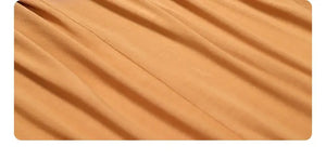 Close-up of orange pleated fabric from dress