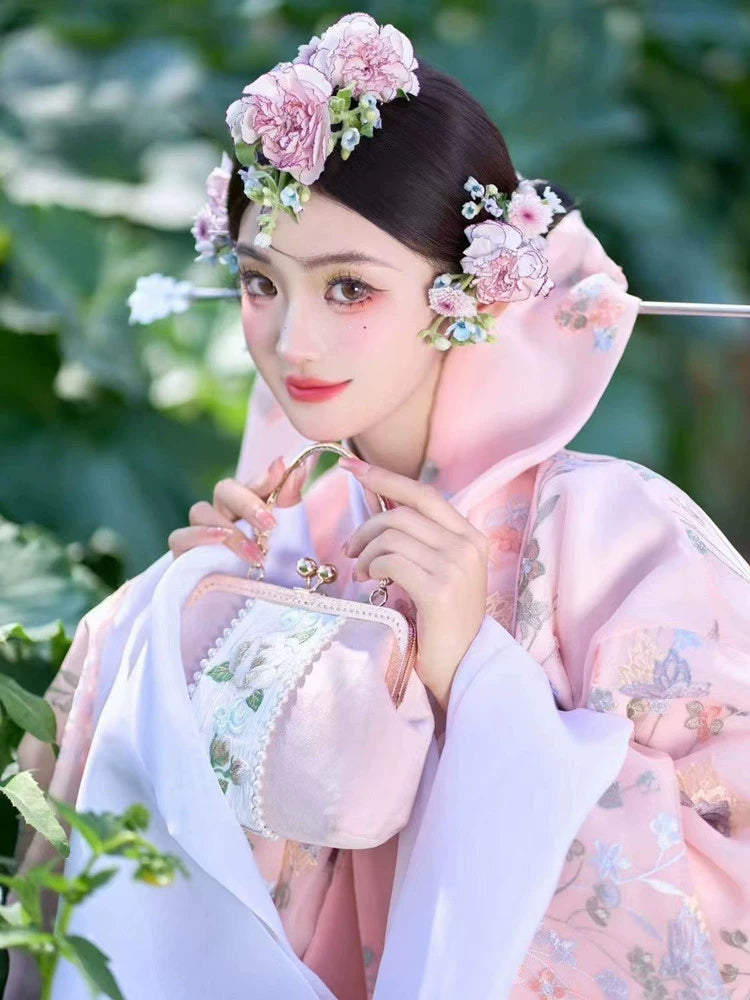 Pink Korean court dress with floral embroidery, paired with a matching purse.