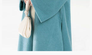Teal coat pocket, cuff and fabric detail