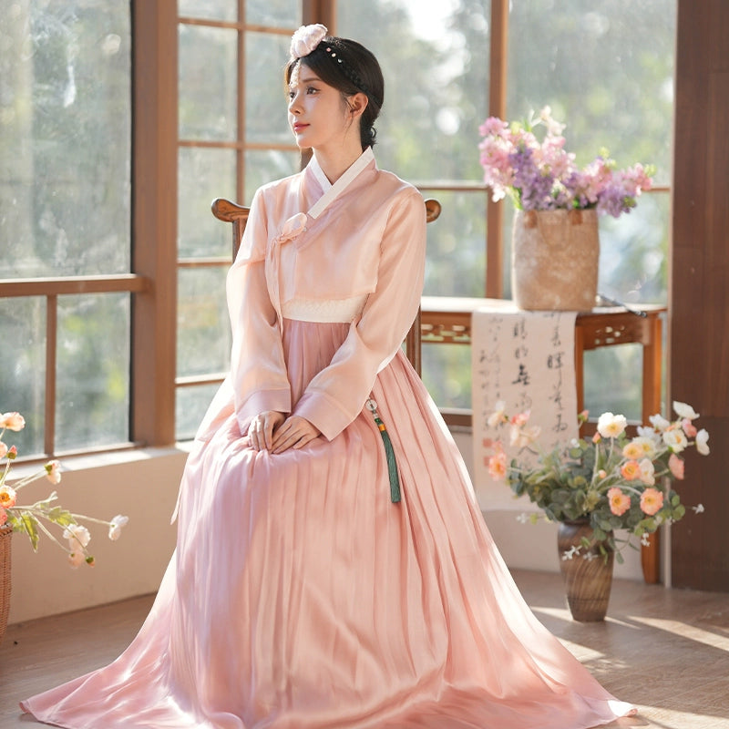 White inner dress worn under a pink hanbok, featuring a delicate lace hem. A versatile and elegant piece for layering.