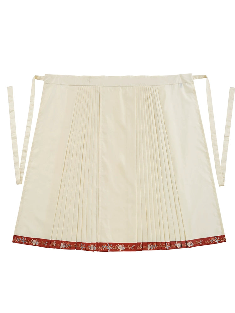 Cream pleated skirt with red embroidered hem, designed to complement traditional Hanfu-style cheongsam dresses.