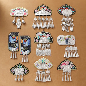 Guizhou Miao fridge magnets featuring handmade embroidery and silver fringe in various ethnic patterns, ideal for cultural home decor.