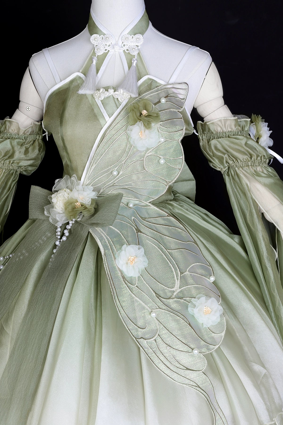 Detailed embroidery on Flower Marriage Green Lolita Dress featuring butterfly wing and floral accents for a whimsical look.