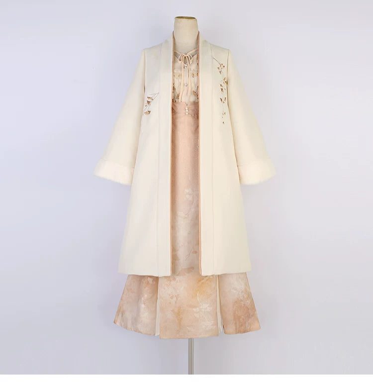 Apricot modern Hanfu coat, floral blouse and long skirt displayed together on a mannequin