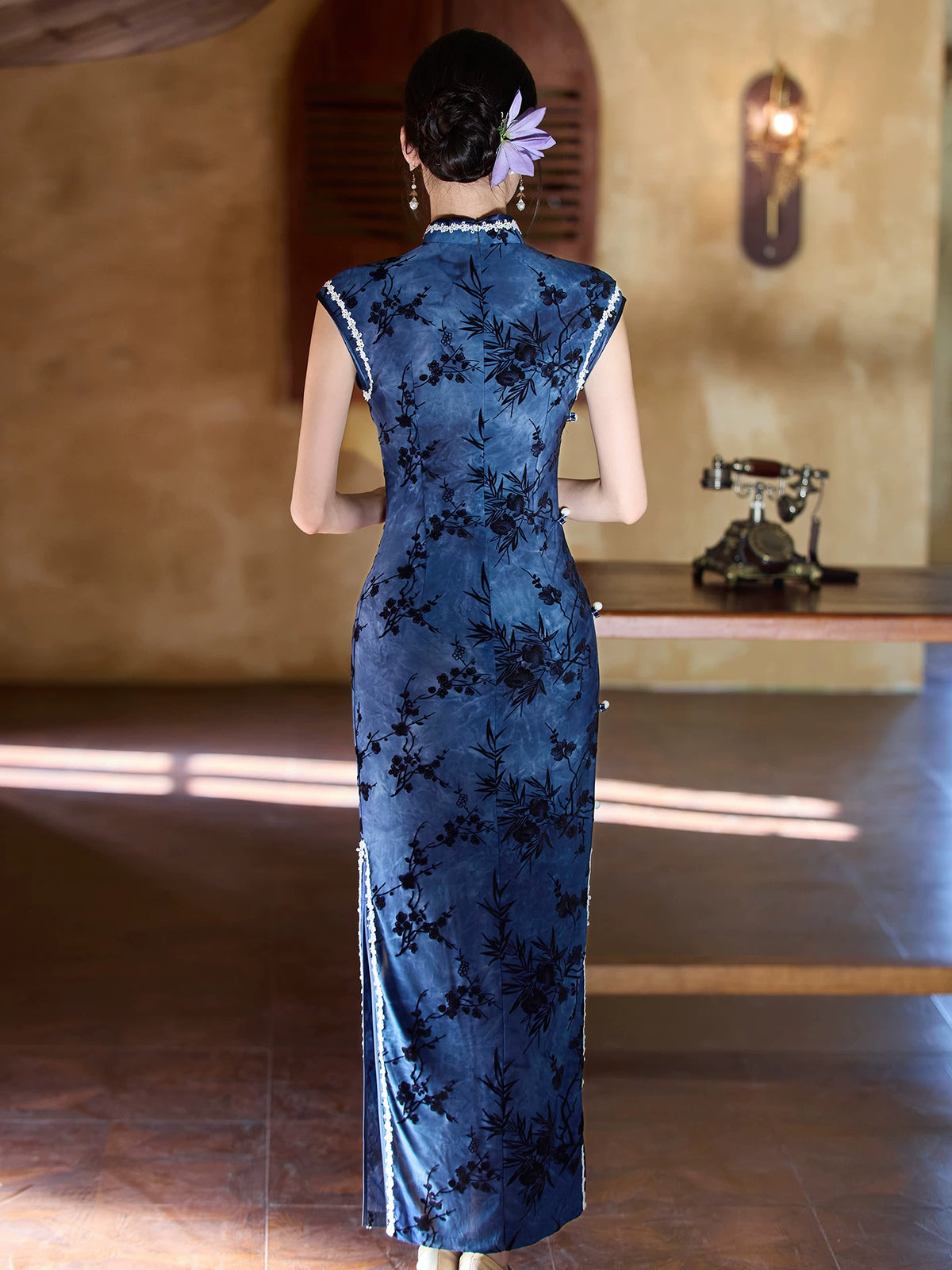 Back view of the blue bamboo sleeveless cheongsam showing the fitted waist and long skirt