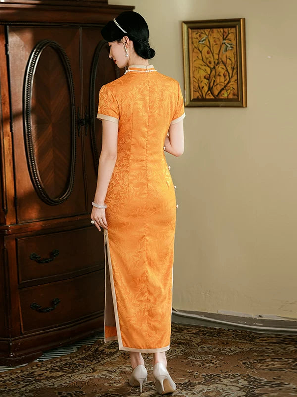 Back view of the orange short-sleeve cheongsam showing the fitted waist and calf-length hem