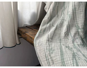 Green contrast trim and bamboo leaf pattern detail on the long cotton robe