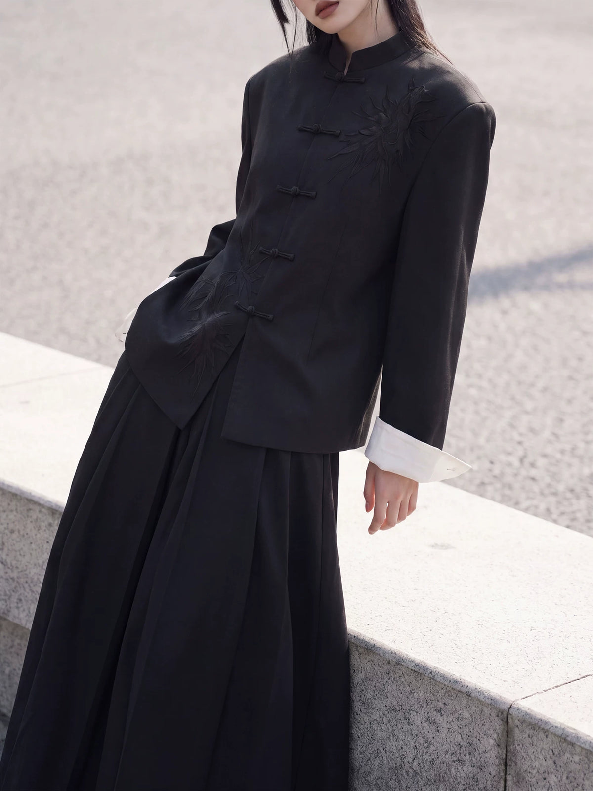 Black Chinese blazer showing straight-cut sleeves and pale cuff lining