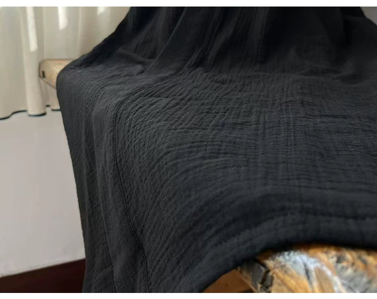 Flowing hem and lightweight texture of the long black cotton robe