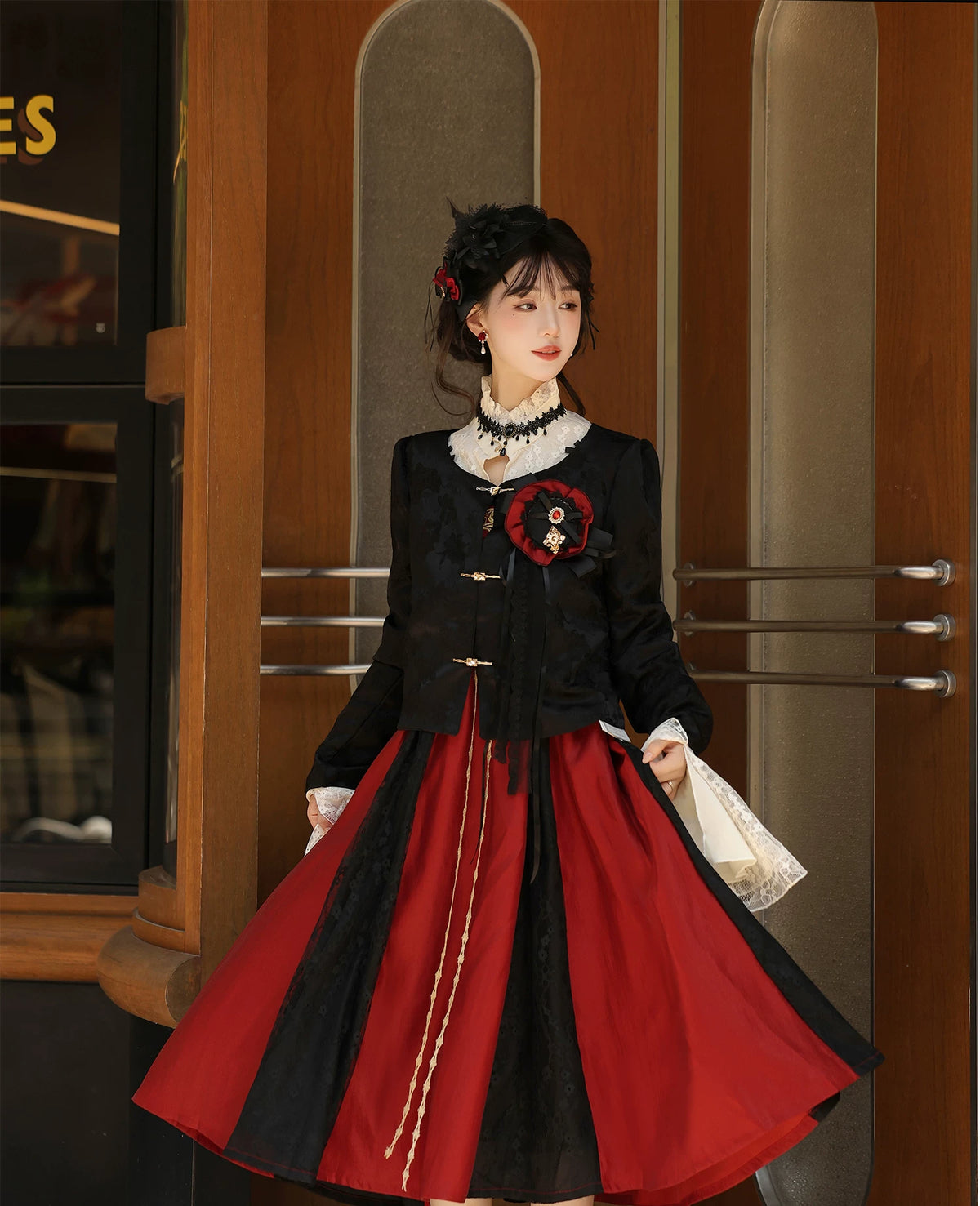 Black jacquard jacket with silver-tone closures worn over the outfit