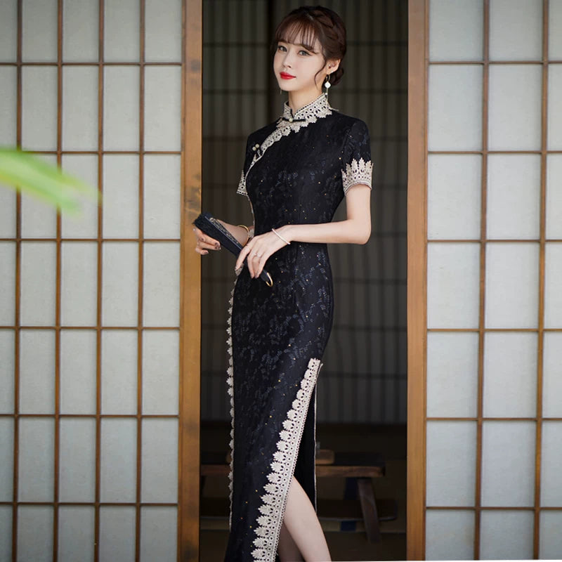 Black lace cheongsam showing the stand collar, short sleeves and scalloped contrast edging