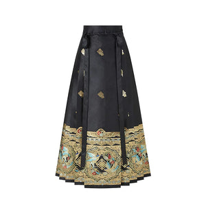 Black magpie mamian skirt with small woven motifs, waist ties and a wide gold-tone border