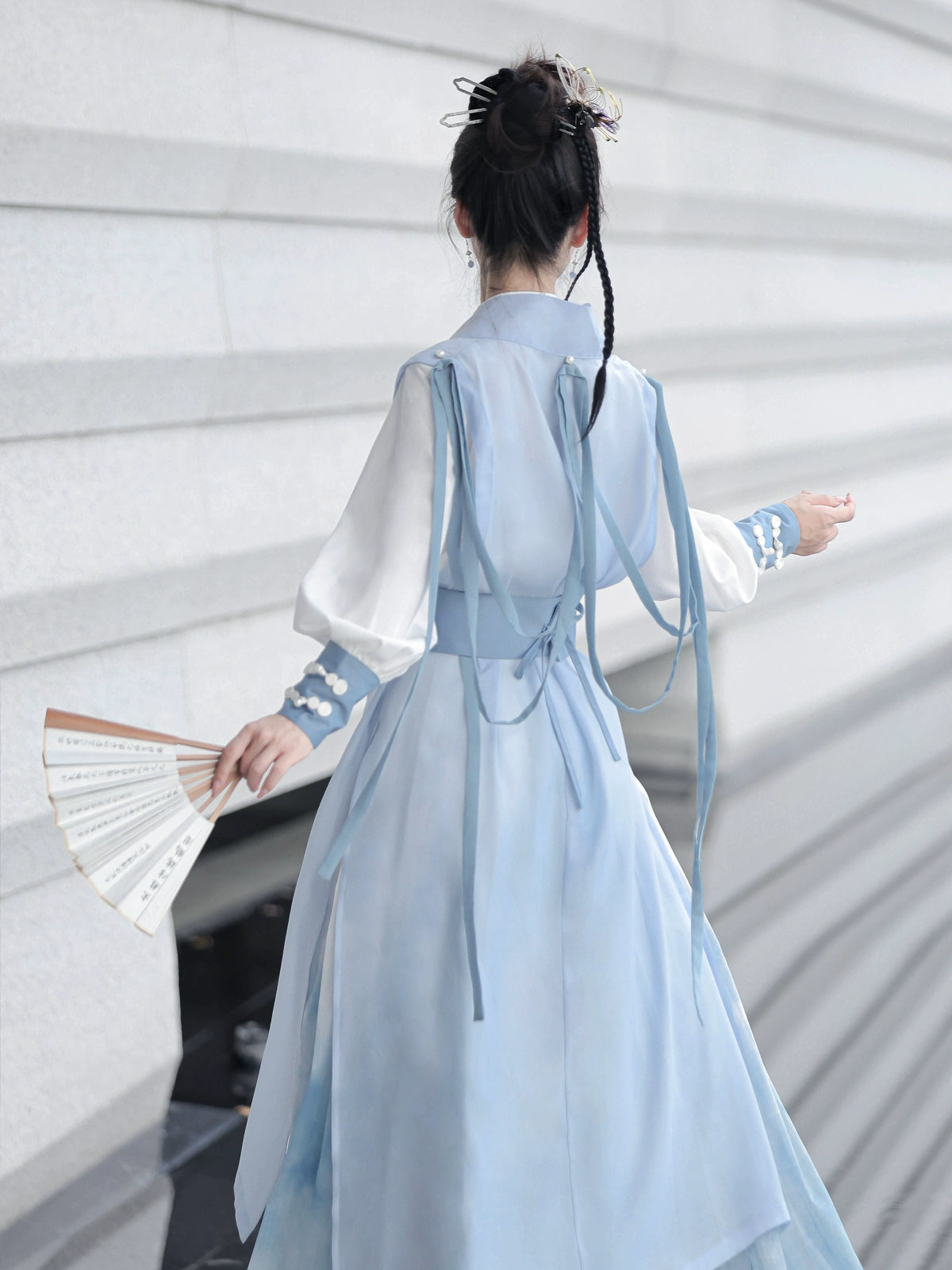 Blue hanfu dress for women, blending traditional Song Dynasty and modern Chinese styles, crafted from luxurious silk. This versatile hanfu includes options for a matching coat or jacket, making it suitable for winter wear, Chinese New Year celebrations, or casual outings. Ideal for occasions like graduations or cosplay, this dress embodies the fairy-inspired elegance of classic hanfu while also drawing from martial arts clothing and contemporary Chinese fashion. Available for purchase in our online hanfu sh