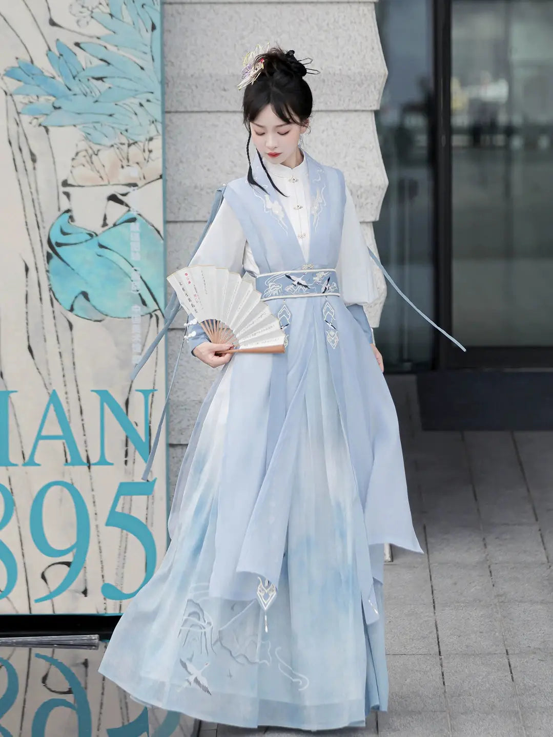 Blue hanfu dress for women, blending traditional Song Dynasty and modern Chinese styles, crafted from luxurious silk. This versatile hanfu includes options for a matching coat or jacket, making it suitable for winter wear, Chinese New Year celebrations, or casual outings. Ideal for occasions like graduations or cosplay, this dress embodies the fairy-inspired elegance of classic hanfu while also drawing from martial arts clothing and contemporary Chinese fashion. Available for purchase in our online hanfu sh