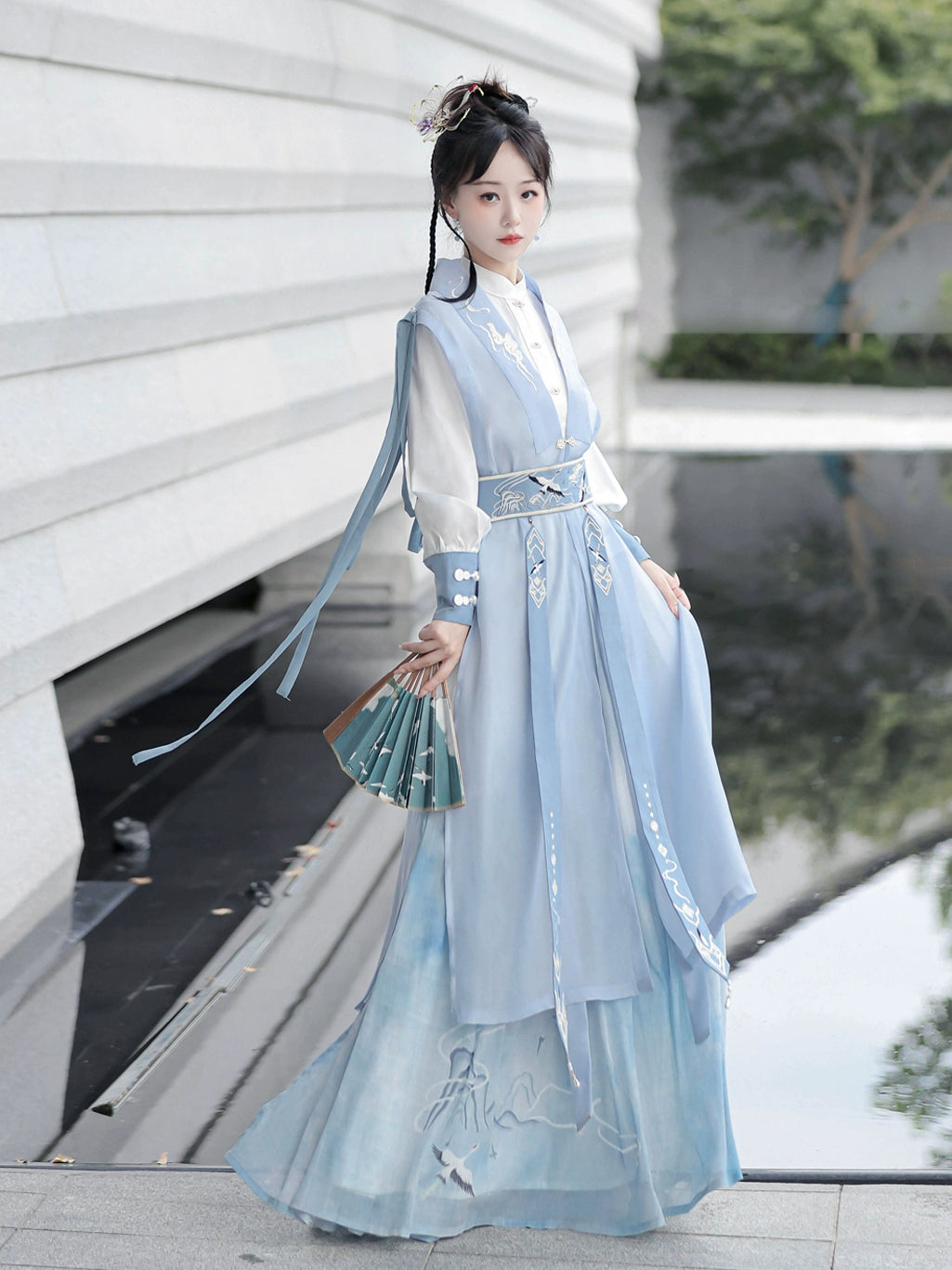 Blue hanfu dress for women, blending traditional Song Dynasty and modern Chinese styles, crafted from luxurious silk. This versatile hanfu includes options for a matching coat or jacket, making it suitable for winter wear, Chinese New Year celebrations, or casual outings. Ideal for occasions like graduations or cosplay, this dress embodies the fairy-inspired elegance of classic hanfu while also drawing from martial arts clothing and contemporary Chinese fashion. Available for purchase in our online hanfu sh