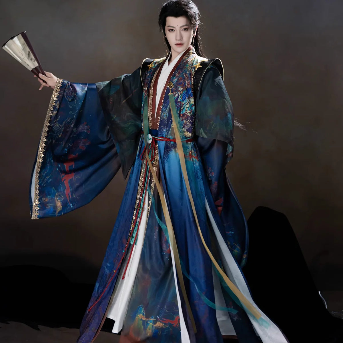 Blue xianxia Hanfu robes with a wide sleeve extended, gold-tone trim and flowing ribbons