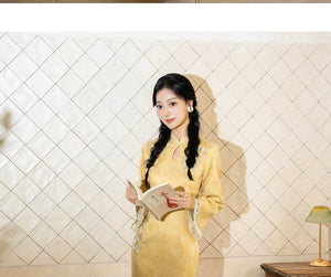 Yellow qipao with long sleeves, standing view