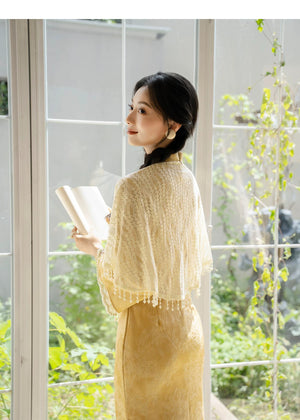 Ivory shawl worn over yellow qipao, rear view