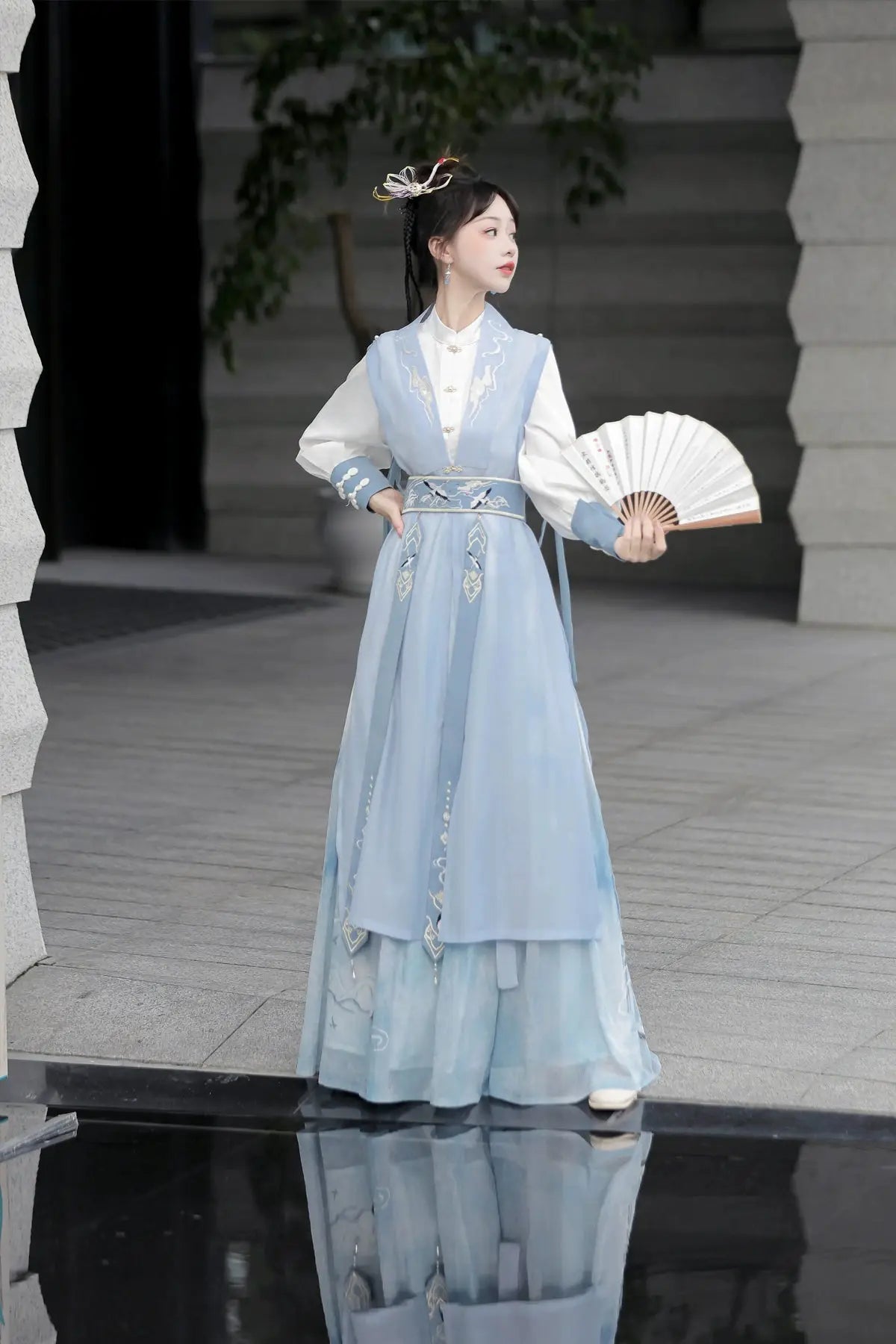 Blue hanfu dress for women, blending traditional Song Dynasty and modern Chinese styles, crafted from luxurious silk. This versatile hanfu includes options for a matching coat or jacket, making it suitable for winter wear, Chinese New Year celebrations, or casual outings. Ideal for occasions like graduations or cosplay, this dress embodies the fairy-inspired elegance of classic hanfu while also drawing from martial arts clothing and contemporary Chinese fashion. Available for purchase in our online hanfu sh