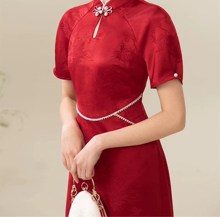 Additional styling view of the Ceremonial Red jacquard engagement qipao dress, showing the garment's shape, texture and finish.