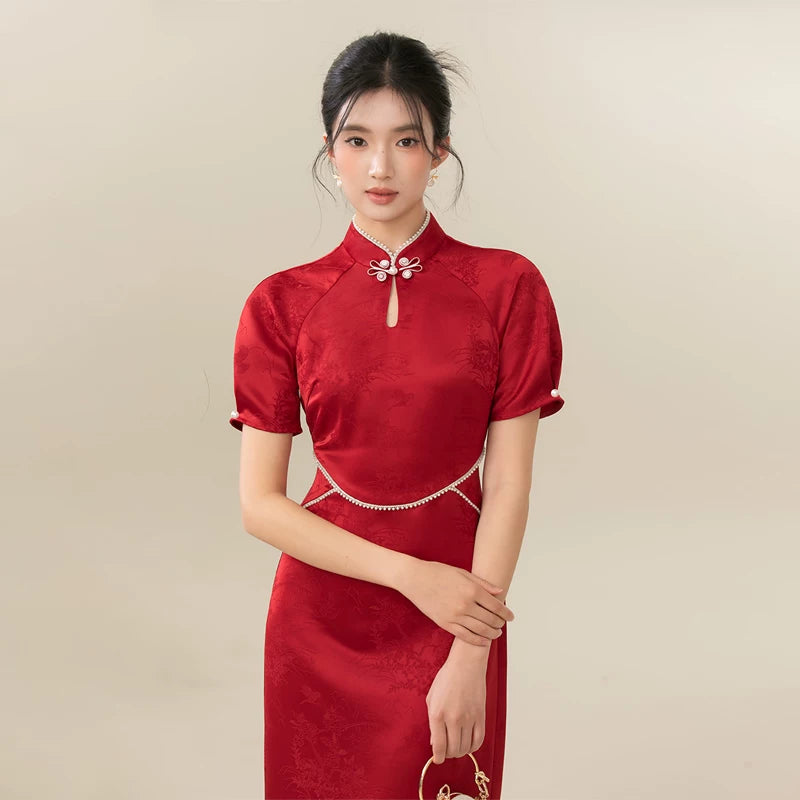 Ceremonial Red jacquard engagement qipao dress shown as a polished red Chinese wedding qipao, highlighting rich jacquard texture, fitted cheongsam shape and engagement-ready red color.