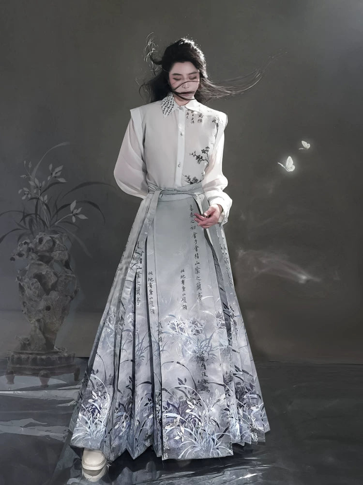 Clivia blue-gray mamian skirt with a white shirt, front view showing a tied waist and long pleated hem.