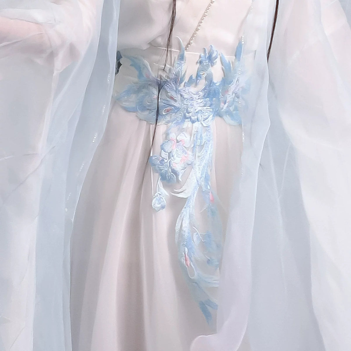 Close-up of the pale blue decorative waist sash