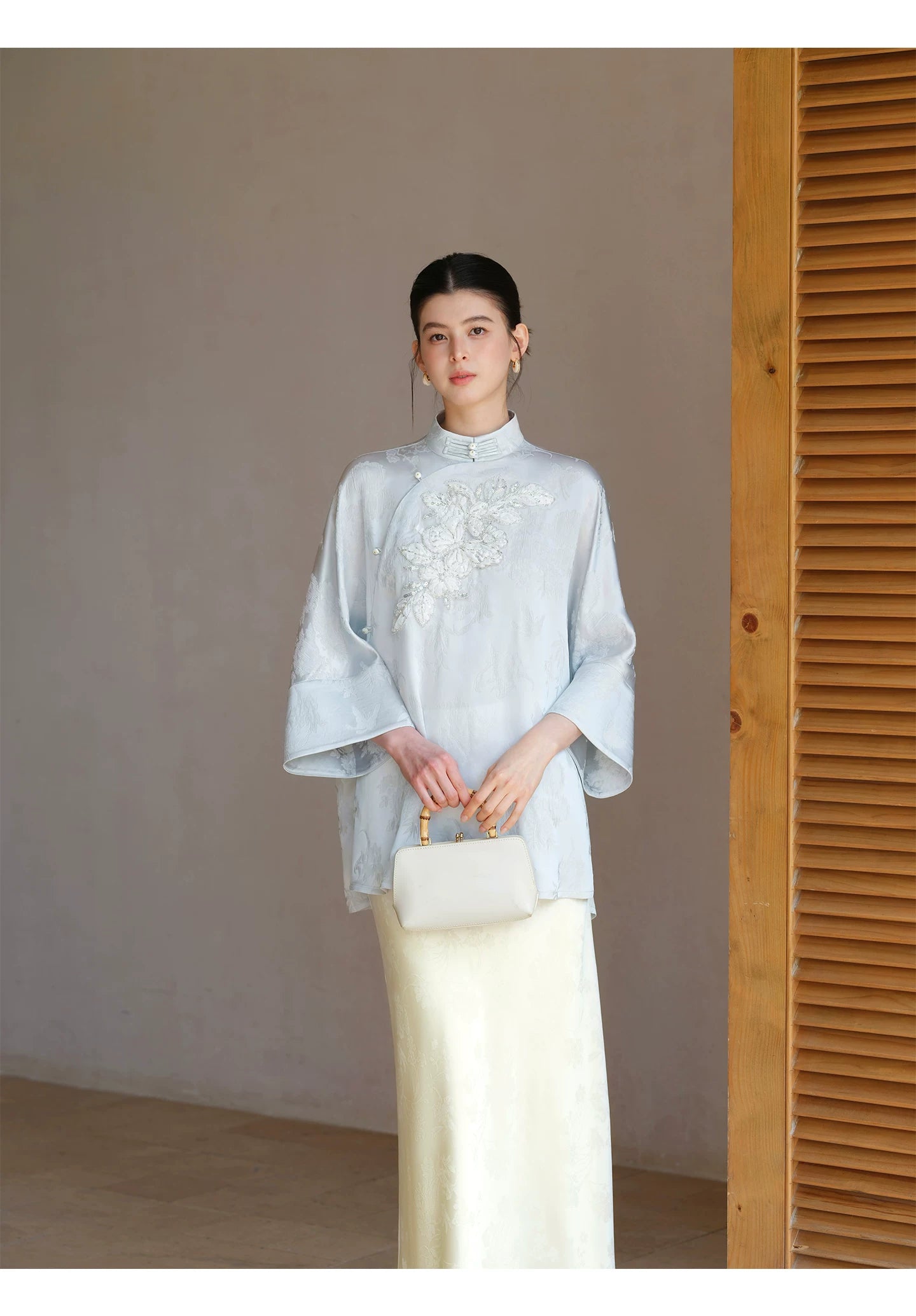 Design view of the Cloud-Mist Blue embroidered satin top and skirt, highlighting floral bead embroidery, stand collar and fluid satin silhouette.