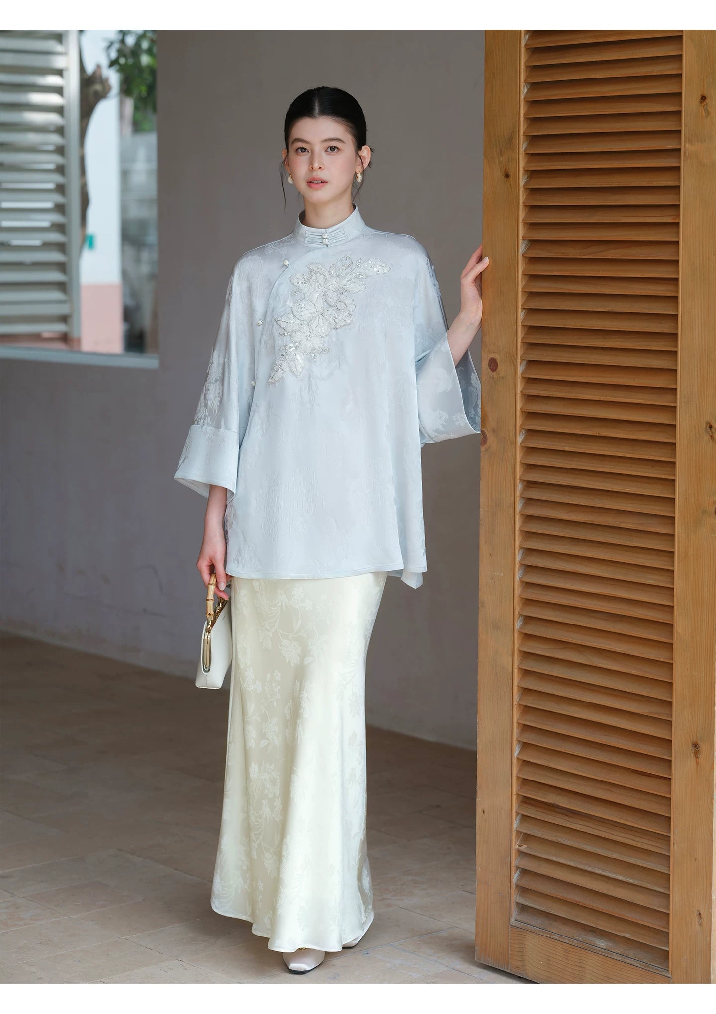 Silhouette and fit view of the Cloud-Mist Blue embroidered satin top and skirt, a contemporary New Chinese Style outfit.