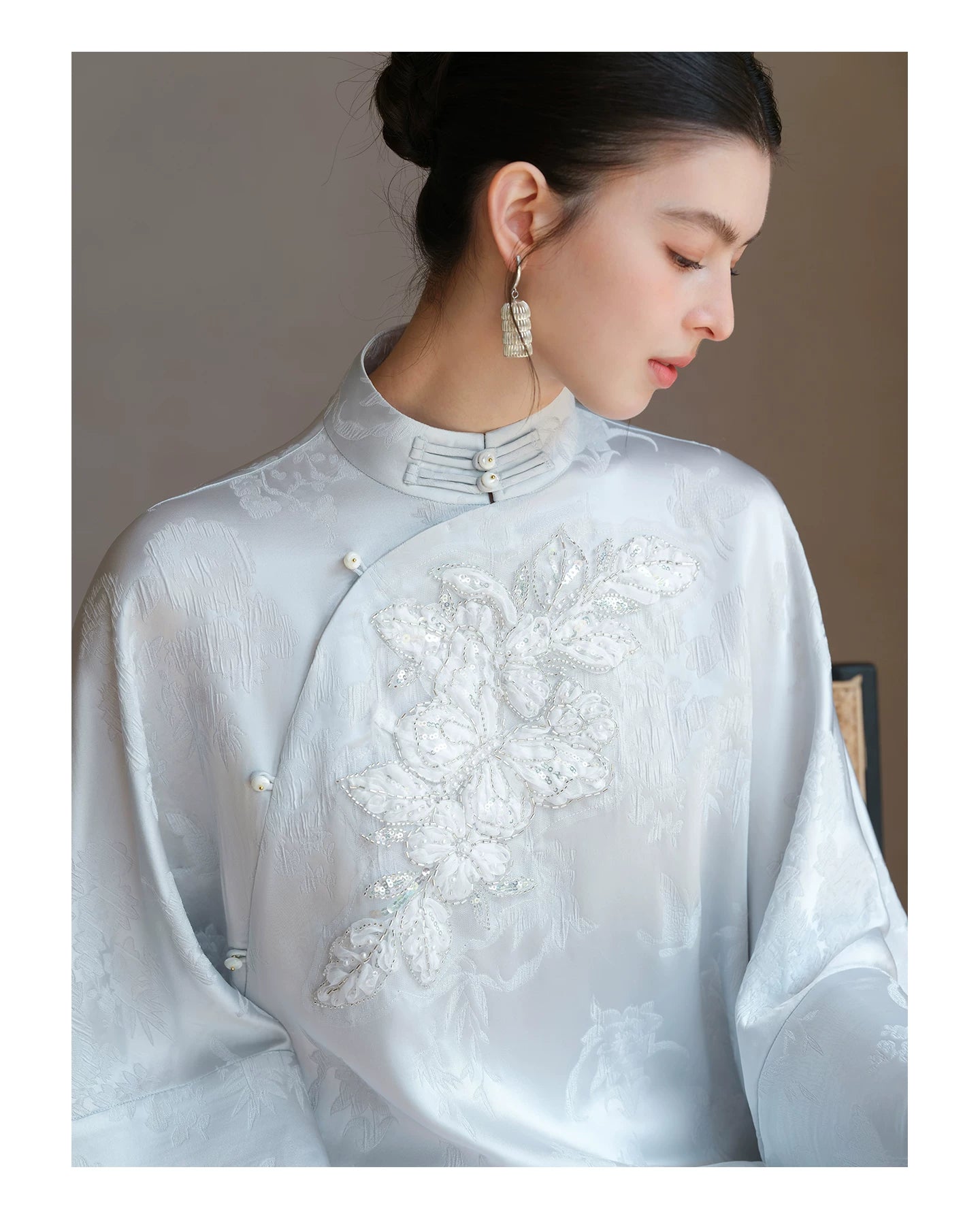 Occasion styling image of the Cloud-Mist Blue embroidered satin top and skirt, presented as an elegant New Chinese Style outfit.