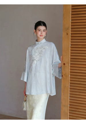 Cloud-Mist Blue embroidered satin top and skirt shown as a polished New Chinese Style outfit, highlighting floral bead embroidery, stand collar and fluid satin silhouette.