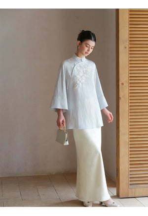 Front styling view of the Cloud-Mist Blue embroidered satin top and skirt, with floral bead embroidery, stand collar and fluid satin silhouette.