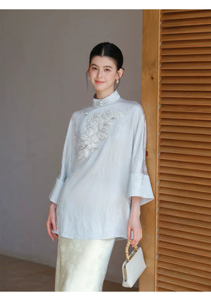 Three-quarter product view of the Cloud-Mist Blue embroidered satin top and skirt, a refined New Chinese Style outfit for elegant occasions.