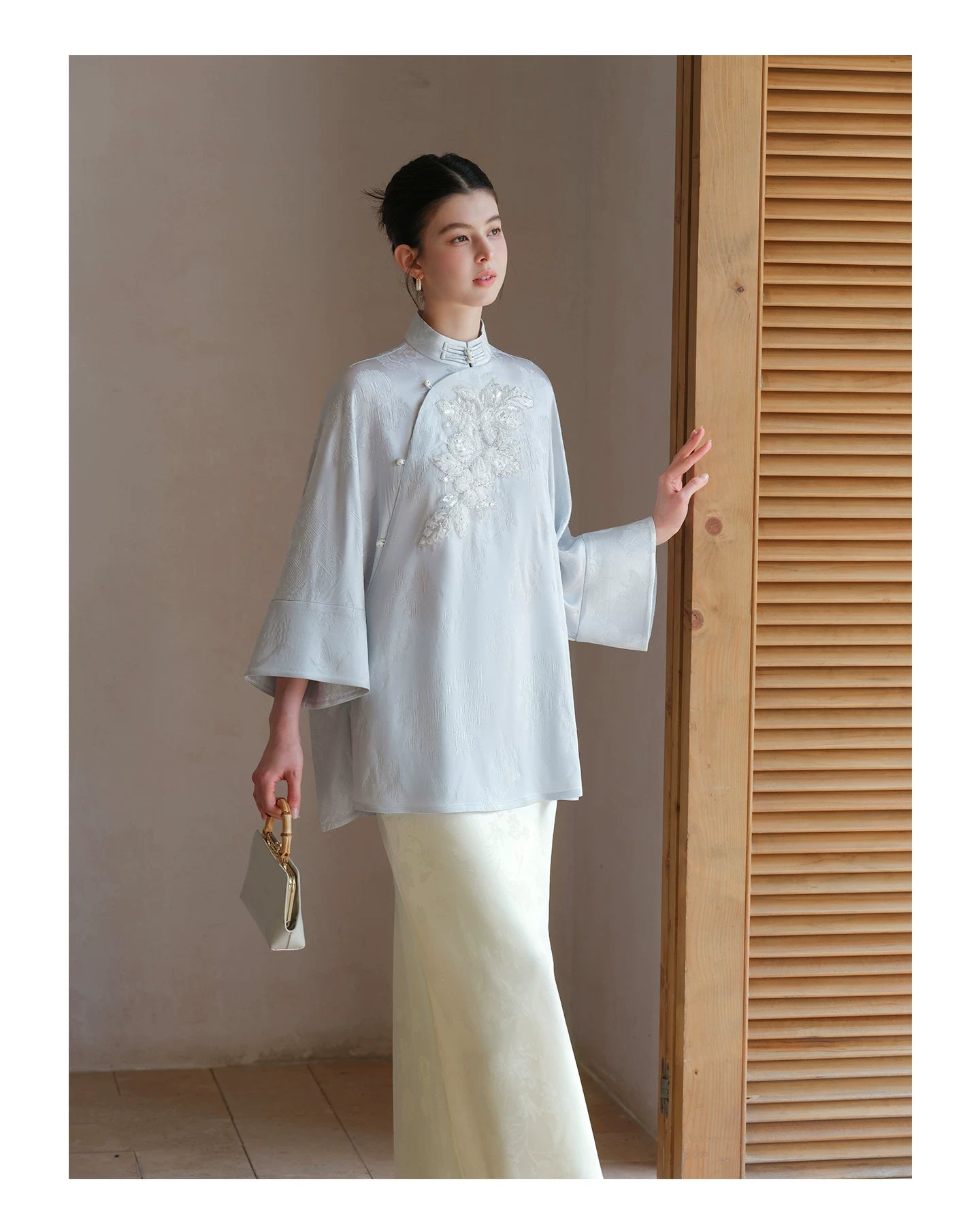 Design view of the Cloud-Mist Blue embroidered satin top and skirt, highlighting floral bead embroidery, stand collar and fluid satin silhouette.