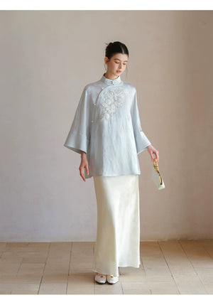 Detailed product image of the Cloud-Mist Blue embroidered satin top and skirt, showing fabric texture, finish and craftsmanship.