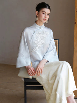 Three-quarter product view of the Cloud-Mist Blue embroidered satin top and skirt, a refined New Chinese Style outfit for elegant occasions.