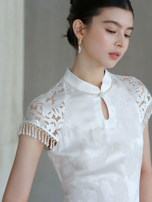 Design view of the Crane White cutwork tassel qipao dress, highlighting cutwork detailing, tassel accents and a graceful modern cheongsam shape.