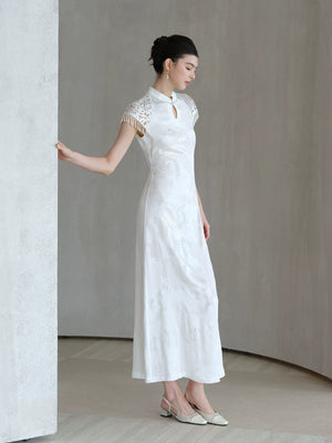 Three-quarter product view of the Crane White cutwork tassel qipao dress, a refined white qipao dress for elegant occasions.