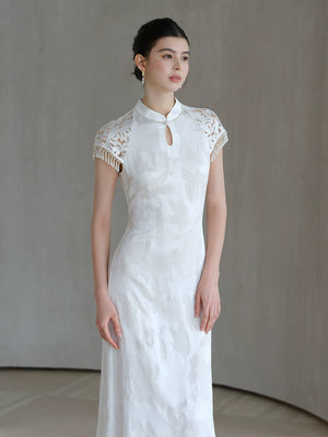 Crane White cutwork tassel qipao dress styled to show its fit and drape, including cutwork detailing, tassel accents and a graceful modern cheongsam shape.