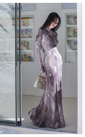 Woman wearing a long, light-colored dress with a blurred background