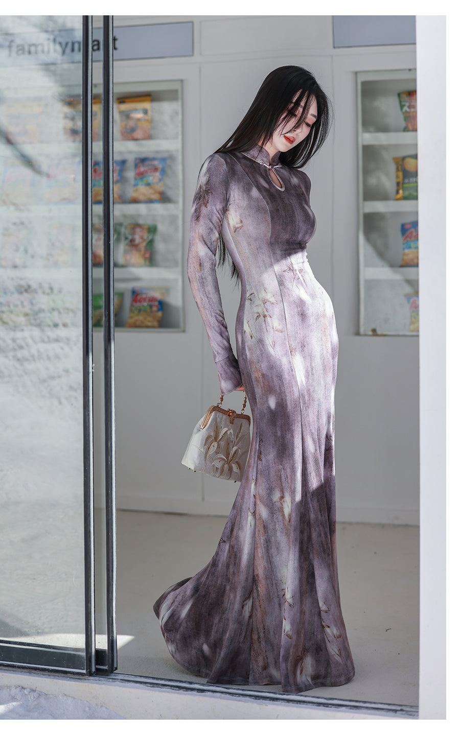 Woman wearing a long, light-colored dress with a blurred background