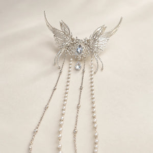 Close-up of butterfly ornament and hanging chains
