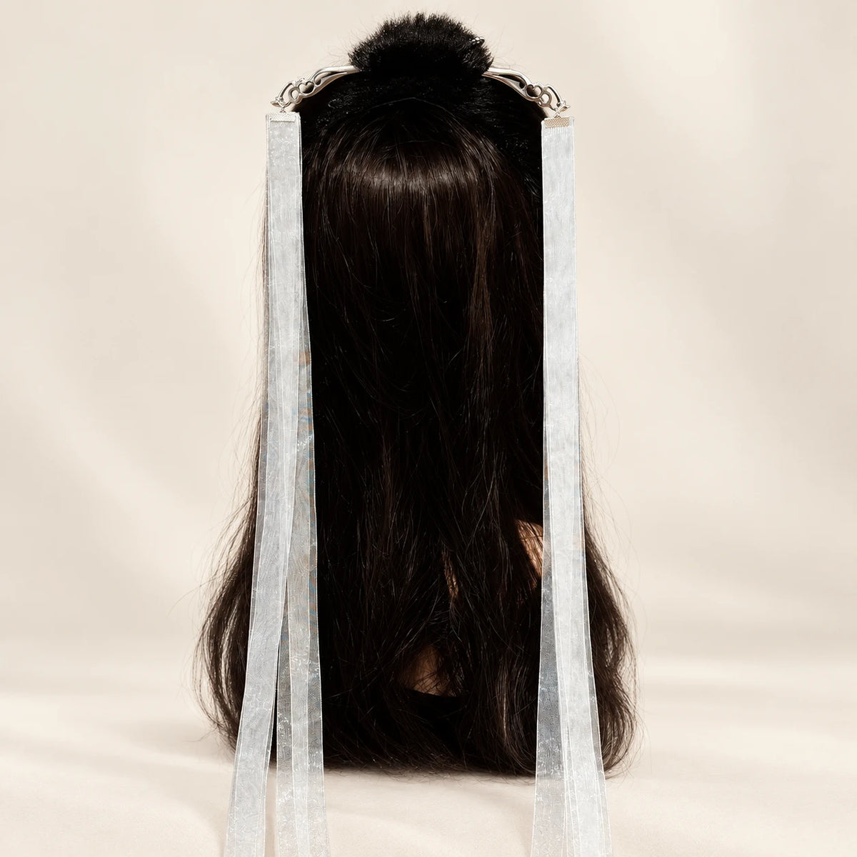 Long ribbon hairpin displayed on a wig