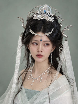Silver-tone dragon halo and crown styled with a pale green outfit