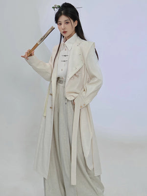 Beige dragon embroidery long coat styled open over light separates, showing the long silhouette and stand-collar neckline of this unisex Chinese style layer.