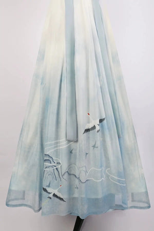 Blue hanfu dress for women, blending traditional Song Dynasty and modern Chinese styles, crafted from luxurious silk. This versatile hanfu includes options for a matching coat or jacket, making it suitable for winter wear, Chinese New Year celebrations, or casual outings. Ideal for occasions like graduations or cosplay, this dress embodies the fairy-inspired elegance of classic hanfu while also drawing from martial arts clothing and contemporary Chinese fashion. Available for purchase in our online hanfu sh