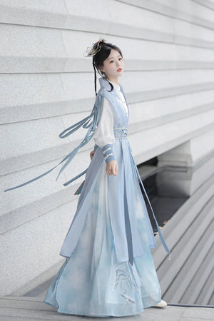 Blue hanfu dress for women, blending traditional Song Dynasty and modern Chinese styles, crafted from luxurious silk. This versatile hanfu includes options for a matching coat or jacket, making it suitable for winter wear, Chinese New Year celebrations, or casual outings. Ideal for occasions like graduations or cosplay, this dress embodies the fairy-inspired elegance of classic hanfu while also drawing from martial arts clothing and contemporary Chinese fashion. Available for purchase in our online hanfu sh