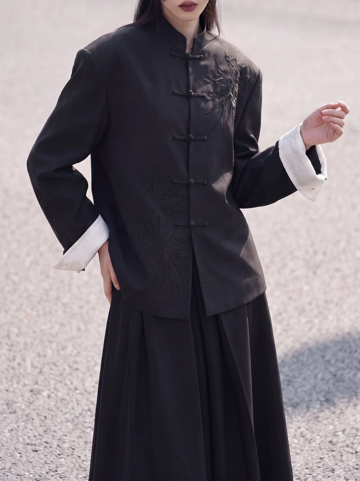 Front view of the black bamboo blazer with frog closures