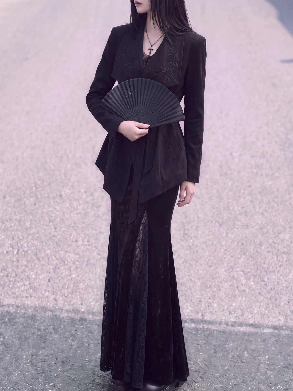 Front view of the black belted jacket with wide lapels